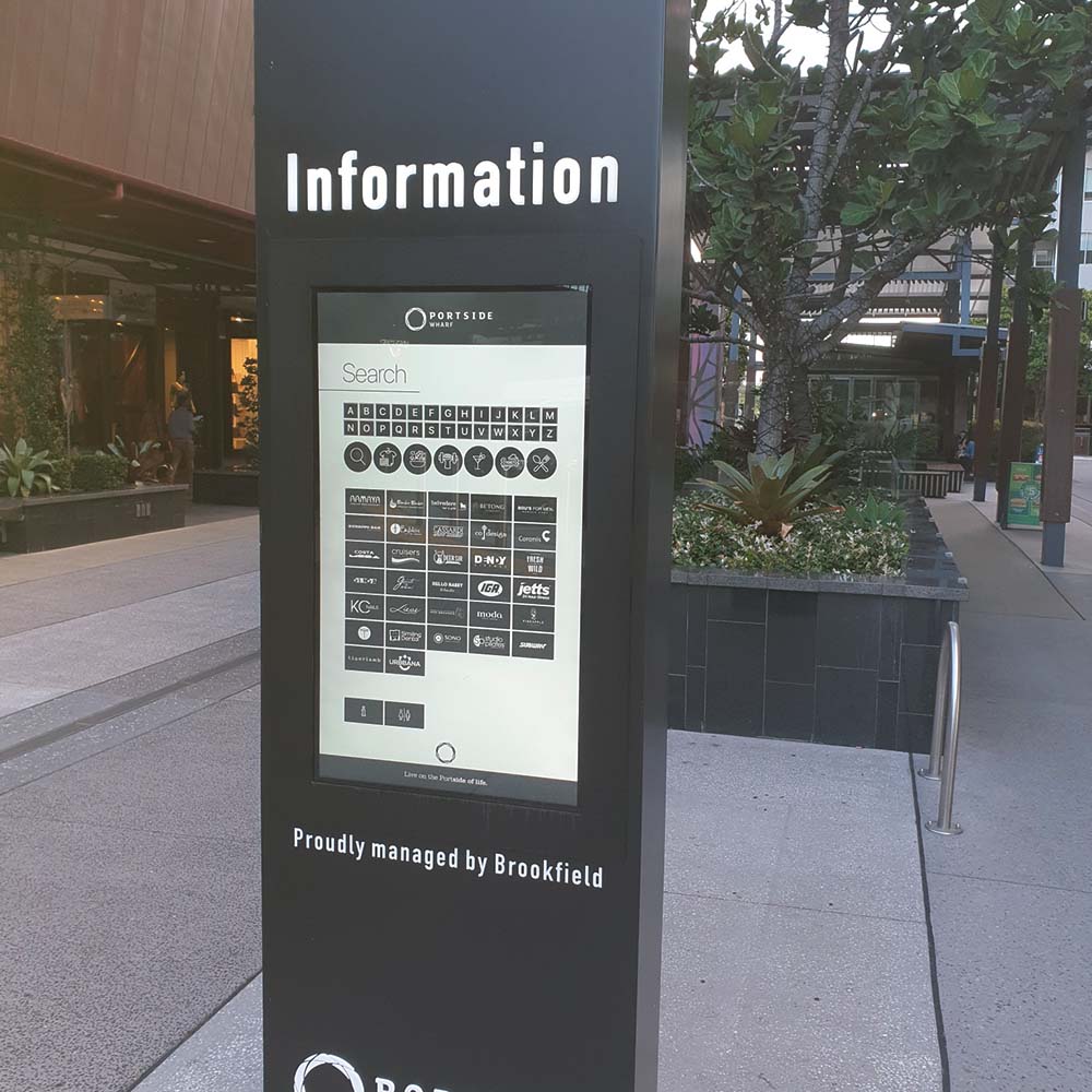 Portside Wharf information totem with a touchscreen directory showing an A to Z search and tenant logos